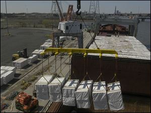 Rov lumber is unloaded from  the M.V. Menominee - the first foriegn ship to visit Toledo.  blade photo by herral long 4/14/2004