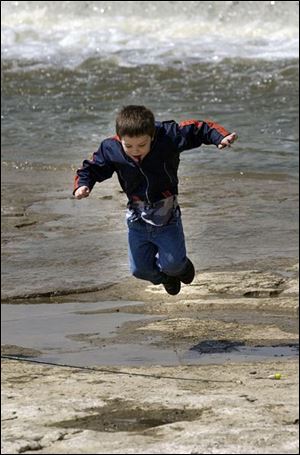 ROV April 16, 2004 - Quentin Atllman, 3,  (cq by dad) leaps over some water while waiting on the rocks as his dad David was fishing in the Maumee River in Providence Metropark, near the Providence Dam, Friday afternoon.  Blade photo by Dave Zapotosky
