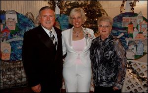 AT HOME: From left, Dick Fisher, Chrys Peterson, and Sandy Fisher make themselves at home during the East Toledo Family Center's Renaissance Gala.