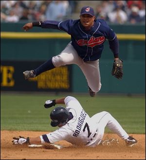 Detroit's Ivan Rodriguez is forced out at second base, but his hard slide kept the Tigers momentarily alive in the ninth inning as Rondell White beat the throw to first from Indians second baseman Ronnie Belliard.