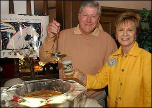 SIP OF THE SOUTH: Paul Churdar ladles a bit of mint julep into an official Derby glass so his wife, Diane, can have a taste too at the Sylvania Country Club.