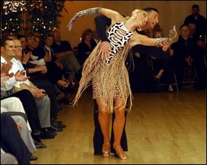 GIVING IT A WHIRL: Alain Doucet and Anik Jolicoeur, four-time world ballroom dance champions, strut their stuff at Alfredo's School of Dance.