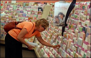 Like many another shopper just before Mother's Day, Lori Zientara Edgeworth, of Toledo, looks over a selection of cards, at Gen's Hallmark Store in Westgate Shopping Center.