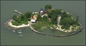 Two developers continue trying to resolve the delays that have dogged construction of a tourist facility on the 1.5-acre Turtle Island, which straddles the Ohio-Michigan line in Lake Erie.