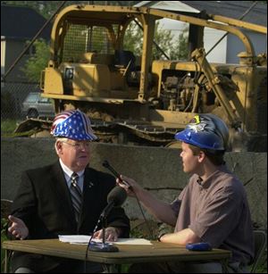Defiance Mayor Bob Armstrong gives his weekly radio address with WONW's Tom Jeffery from the demolition site.