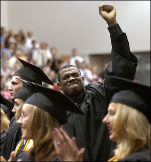 cty grad13p 1 May 13, 2004. Owens Community College graduate Troy L. Awls celebrates his graduation after the singing of the National Anthem during  spring commencement. Blade photo by Jeremy Wadsworth