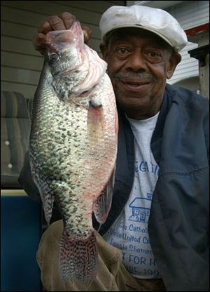 George Taylor, of Toledo, hefts his crappie-of-a-lifetime a 3-pounder.