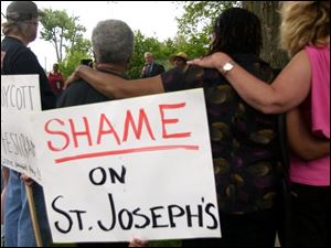 CTY lathrop14p  John McHugh, 53, of Sylvania, speaking across the street from St. Joseph Catholic Church in Sylvania, Ohio on May 14, 2004. Over a score of people came to the Lathrop House in Sylvania, Ohio to protest the removal of the historic house from its foundation. The house, which is believed to have been a stop on the Underground Railroad, is being moved by its owners, St. Joseph Catholic Church. Jetta Fraser/Blade