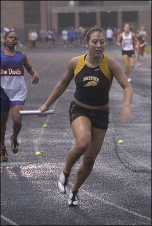 Lindsay Meridieth takes the baton for the anchor leg of the 800-meter relay team. She also won the 100 and 200.