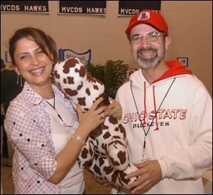 TRUE TO THEIR SCHOOL: Loubna and Omar Salem are in the school spirit as they snuggle a stuffed animal at Maumee Valley Country Day School.