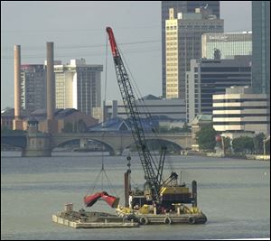 Silt is dredged from the bottom of the Maumee River to keep the Toledo shipping channel open.
