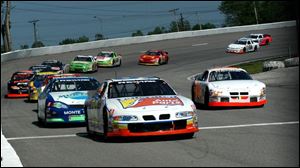 Ken Schrader leads the field in the ARCA/RE-MAX Hickory Farms 200 at Toledo Speedway. Schrader raced in the NASCAR Nextel Cup race Saturday in Richmond, Va.