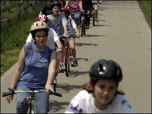 CTY kids12p A  May 12, 2004-- Students in Dan Reinhart's 7th grade science class at Deveaux Junior High School cycle down University Trail on their way back to school. Fifty-five students traveled by bicycle to Wildwood Preserve Metropark Wednesday for a science field trip. Blade photo by Andy Morrison
