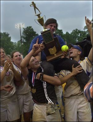 St. Ursula players lift coach Julie Barber and the state championship trophy. The Arrows finish 27-4.