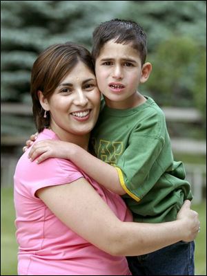 Faris, being held by his mother, Mona Qaimari of Sylvania Township, battles with autism. The brain disorder is the fastest growing developmental disability in America.