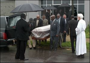 The body of William Brower, Sr., is carried from All Saints Episcopal Church after funeral services. Family and friends said good-bye during an emotional ceremony yesterday.
