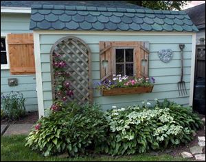 Plantlife adorns a backyard shed at 505 West Broadway.
