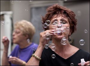 In the Focus on Healing class, Linda Rokicki blows bubbles as part of the breathing therapy.