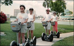Riding Segways through a park in downtown Sarasota are, from left, Carolyn Moorhead of Palm Harbor, Fla.; Jan Hitchings of Indiana, Pa.; Tom Jacobson, owner of Florida Ever-Glides tours, and Alison Kelly of Dayton, Ohio.