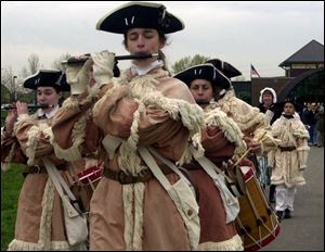 Volunteers in period costumes march into Fort Meigs during the May, 2003, rededication of the renovated War of 1812 fort.