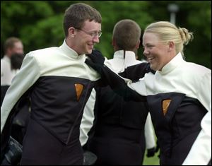Mellophone players Justin Kyne, 18, of Bellbrook, Ohio, and Laura James, 21, of Gibsonburg, Ohio, stretch before playing.