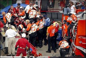 Members of Kasey Kahne's pit crew battled Tony Stewart's crew members Sunday after Stewart knocked Kahne into the wall.