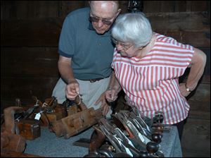 Nbr Photo by Don Simmons July 23, 2004   L to R  Jack Devitt who has tools  on diplay at the 56Barailey Depot on county rd 3   checks the price of one of them for Vera Stever of Delta Ohio  ( tool23p )