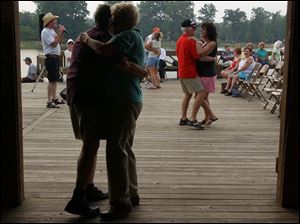 NBR SUNSET21P 2 7/21/04 PHOTO BY LORI KING Couples dance to the music of Bob Wurst at Olander Park. (PS NO SUNSET. CLOUDY)