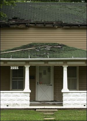 The roof and front porch are deteriorating on the abandoned house at 208 W. Garfield Ave.