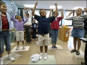 CTY migrant28p A  July 28, 2004-- Vanessa Aguayo,  left, Hector Mena, center, and Monica Gomez,  right, and classmates dance along with music teacher Julie Zedlitz during summer school for children of migrant workers. The three eight year-olds and their classmates were having fun learning Wednesday morning at the class in Delta. Blade photo by Andy Morrison