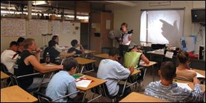 Instructor Katie Miller goes over a mathematics test with students at mason High School.