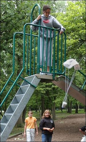 The city wide summer YMCA Teen Camp program  held an egg drop competition at Pearson Metropark. Shown is Lizzie Hoyle,12, dropping her teams parachute design. For questions call Vicky at 419-531-2612. Lisa Dutton 07/26/2004 NBR YMCA27P 1.jpg