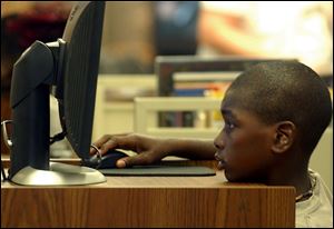 Eleven year old Charles Taylor spent the rainy day playing the Neopets computer game at the Kent Branch Library on Collingwood Blvd. Lisa Dutton ROV rainy dayP .jpg