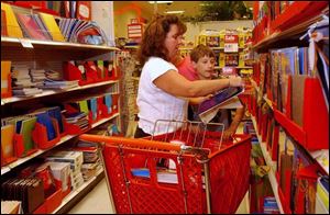 Toledoan Laurie Crawford and her son C.J. go down their list of supplies at Target on Monroe Street. 
