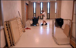 Custodian Sally Hintz helps get the school ready for opening.