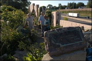 Merle Peoples, Jonathon Parsons, and Don French view their volunteer efforts at the intersection of Sherbrooke Road and the expressway.