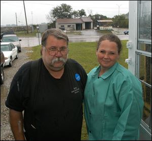 The former Kim's Auto & Truck Service grounds provide a backdrop for owners Herman and Kim Blankenship, who moved their business across Stickney Avenue.