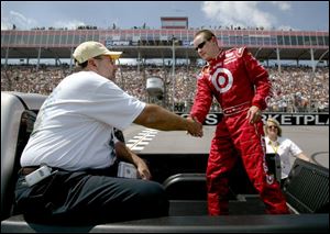 Kent Meyers of Oregon greets Casey Mears as the two prepare to take a spin around the track at Michigan International Speedway. He earned the ride by winning a silent auction for charity.