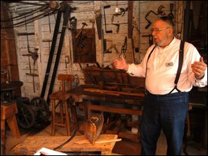 R sauder 1 .jpg Bill Collins of Montpelier gives a tour of Erie Sauders original workshop in Sauder village.  blade photo by herral long  8/17/2004