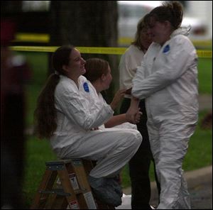 Roxanne Leroux, 14, left, greets Brittany Parenteau, 14, who was the last to be checked for mercury contamination.