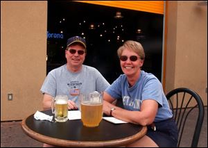 SHADES OF FUN: Bob and Sharon Kwiakowski have a cold one on a hot day on the patio of The Emporium downtown.