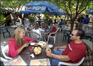 PATIO PATTER: Tonya Yaros and Joshua Belczyk enjoy an evening of south-of-the-border style food at Pepe's in West Toledo.