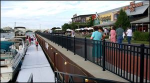 IN ANY OLD WEATHER: The Docks in International Park offer not only a range of restaurants but open-air dining with a spectacular view of the Maumee River and downtown Toledo's skyline.