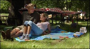 Ben and Angie Swanson wait for other guests to arrive for a picnic at Wildwood Preserve Metropark earlier this summer.