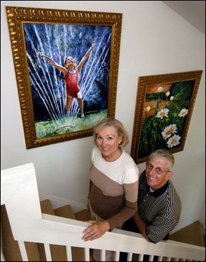 Patty and David Hayes with paintings by Amanda Dunbar.