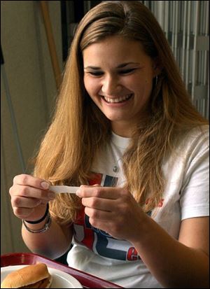 Valerie Lorson of Dover, Ohio, reads her fortune in the University of Toledo's Horton International House cafeteria.