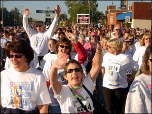 Cty  race19p  Downtown Toledo  by Fifth Third  Field.  Race for the cure. Walkers start up Summit St at the beginning of the walk... They have lots of enthusiam!   Diane Hires  9/19/04