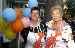LOBSTER APPETITE: Beth Bowman, left, and Sue Lovett are at the Toledo Symphony League event.