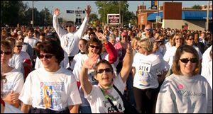 Cty  race19p  Downtown Toledo  by Fifth Third  Field.  Race for the cure. Walkers start up Summit St at the beginning of the walk... They have lots of enthusiam!   Diane Hires  9/19/04