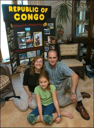 From left, Beth, Chris, and Anna Windom, 10, leave Wednesday for a two-year mission to the Congo.